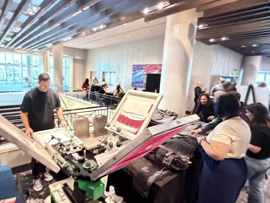 Customization station serving a line of guests in a hotel ballroom foyer