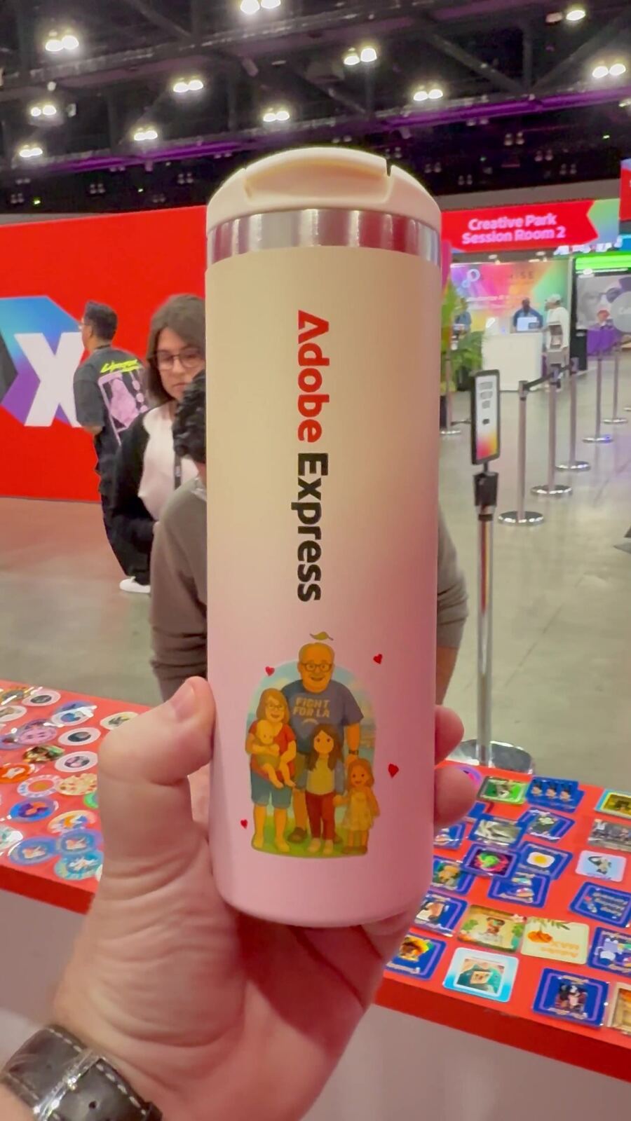Hand holding a custom branded tumbler finished at a drinkware customization station